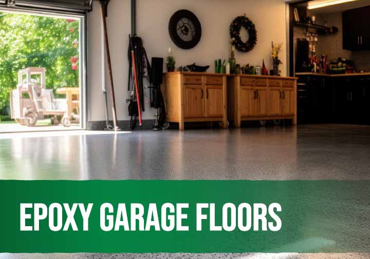 Epoxy coating being applied to a garage floor for a durable and glossy finish.