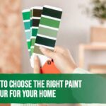 Homeowner comparing paint colour swatches to choose the perfect interior paint for their home.