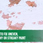 Painter fixing uneven and patchy paint on a wall using a roller for a smooth finish.
