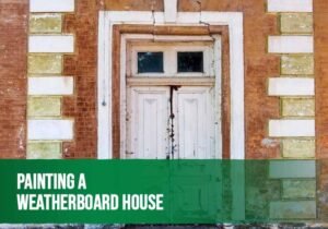 Painter applying fresh exterior paint to a weatherboard house after proper surface preparation.