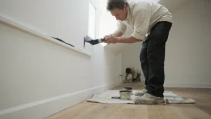 Adelaide interior painter cutting in carefully around a window frame showing the precision edge work of professional painting